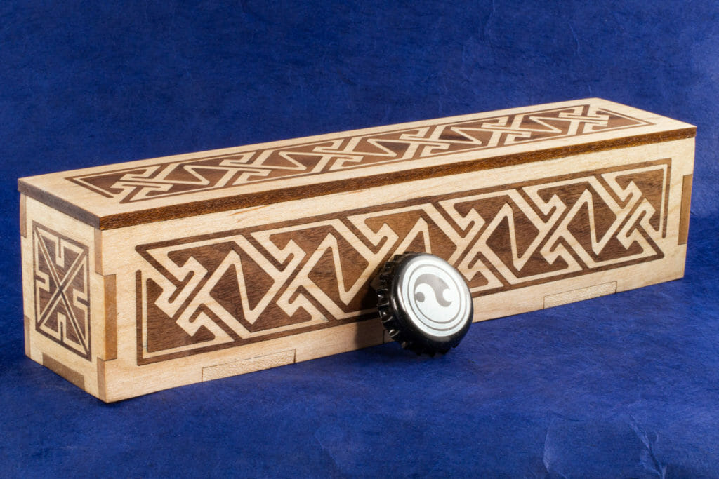Long Inlaid Celtic Key Pattern Box (with bottlecap for scale)