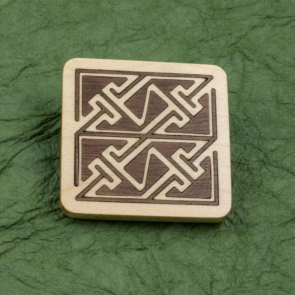 Celtic key pattern walnut in maple inlaid pin.