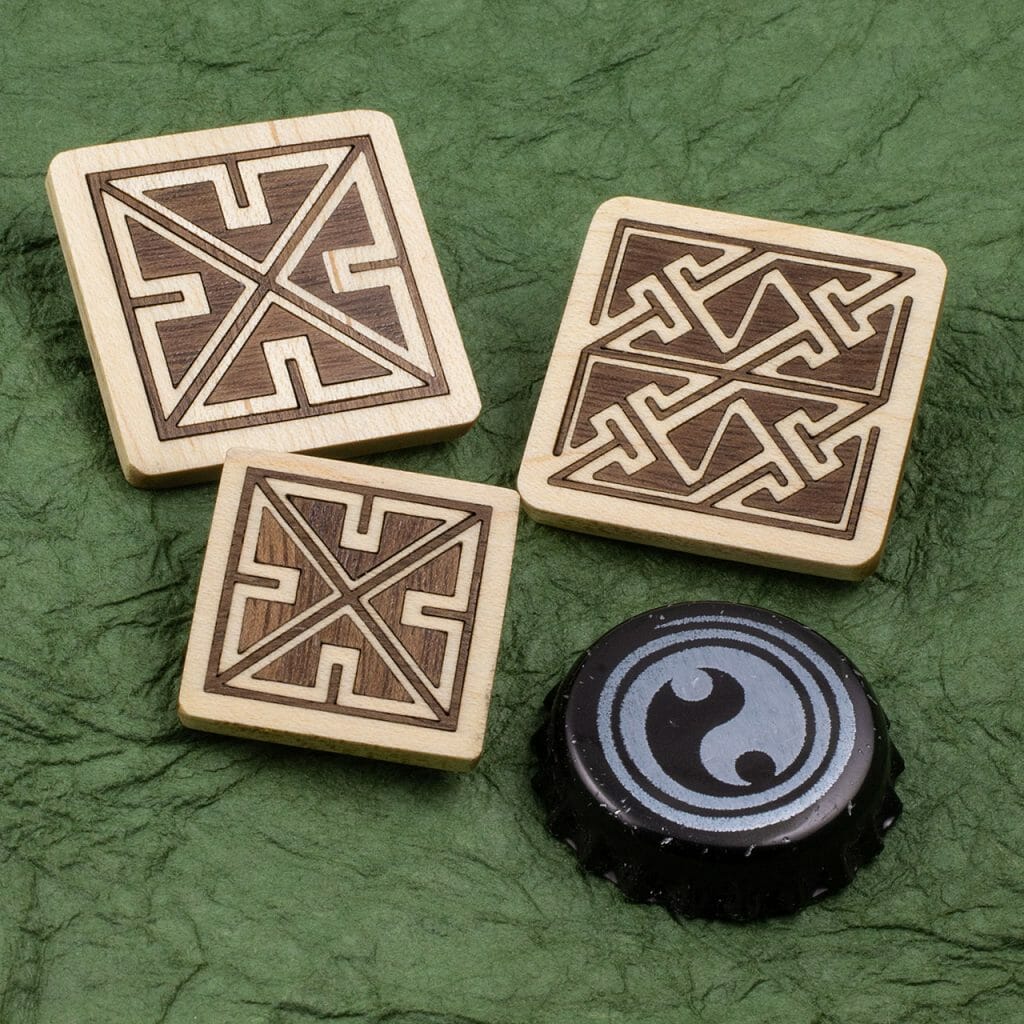 Celtic key pattern walnut in maple inlaid pins with bottle cap for scale.