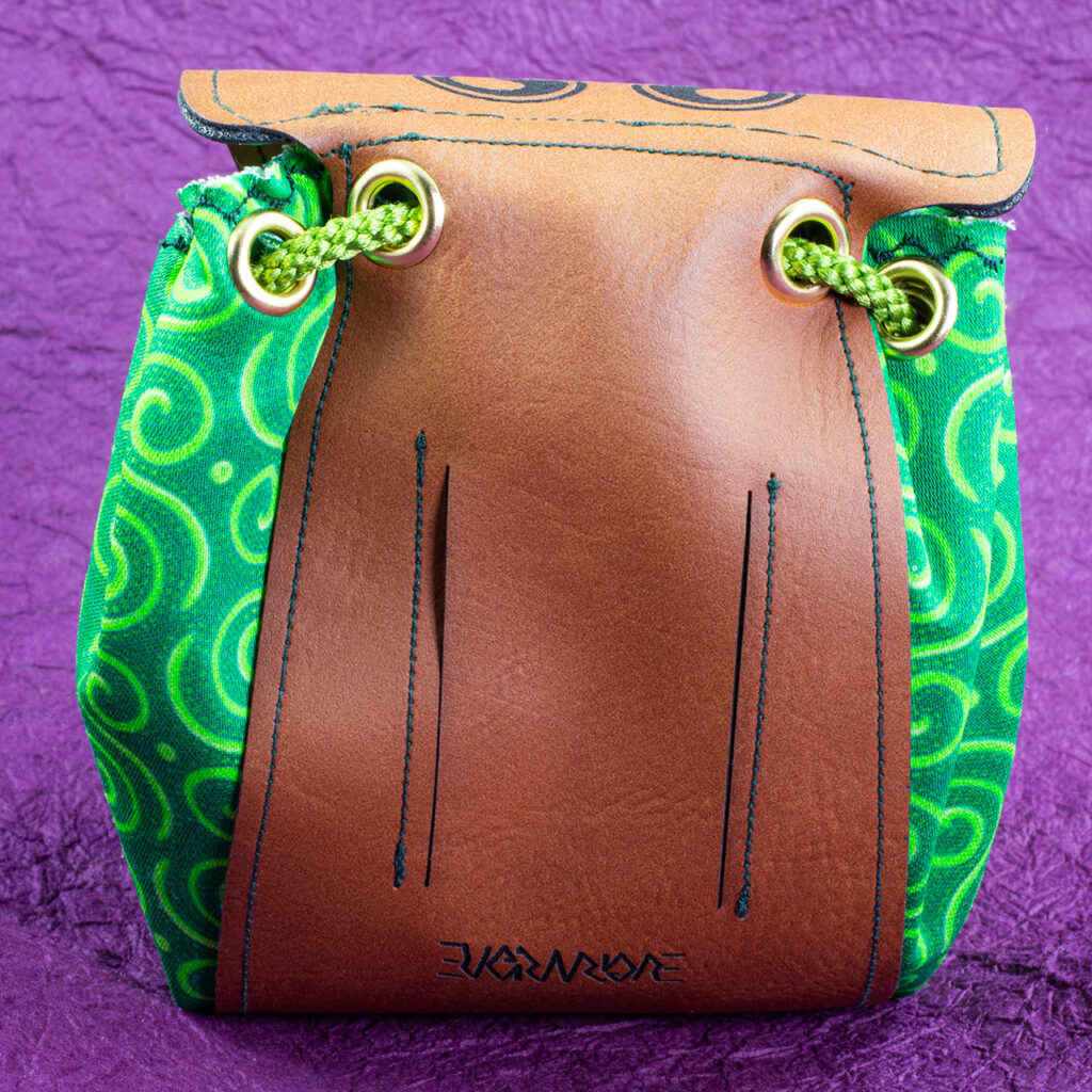 A small fantasy/Medieval belt pouch. The main body is cotton fabric printed with interlocking Celtic spirals in various shades of green. The back has slits to accommodate a belt.