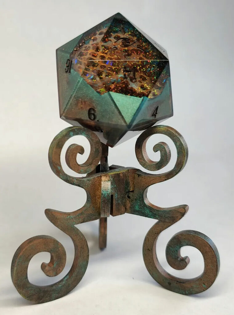 Resin art D20 chonk by @DiceOfTheSeeker on faux copper patina reliquary.