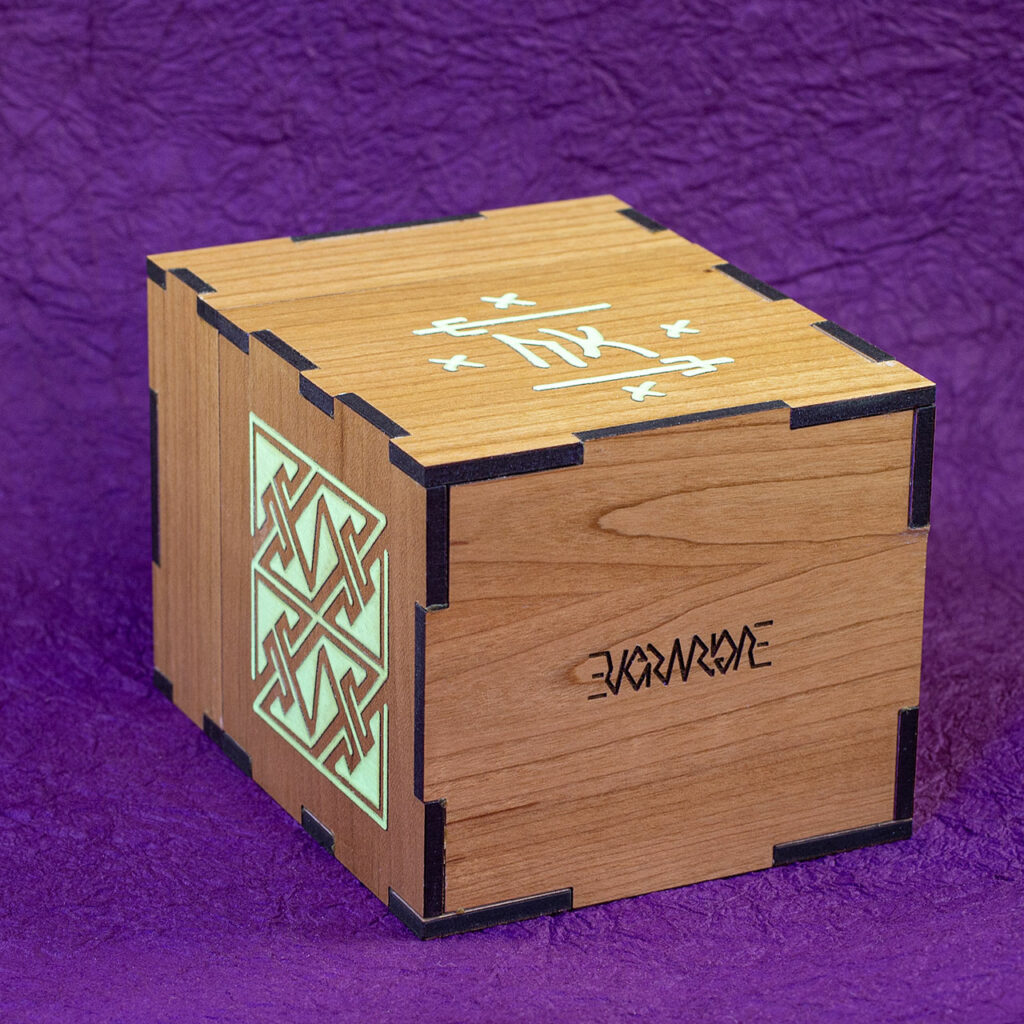 Wood sleeved "commander" deck box for M:tG and similar games with glowing engraved designs: an embellished Futhark rune on the front and, a Celtic key pattern panel on the left side. View of the bottom, showing the Evermore ambigram engrave.