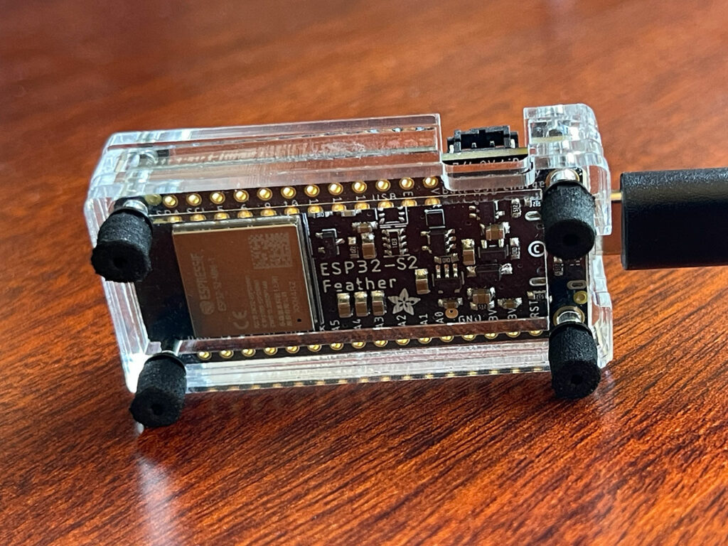 ESP32-S2 TFT Feather running ESPHole in a custom laser-cut acrylic case (bottom).