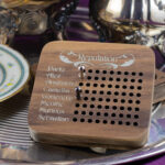 Reputation tracker - a wooden box with a list of names on the face, each with a row of holes that accept cribbage pegs.