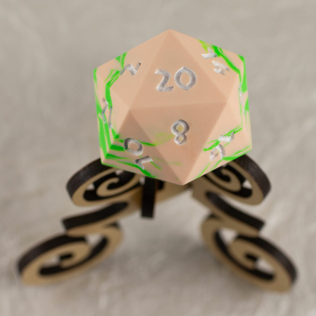 42mm Jesmonite chonk in peach and bright green swirled together, the numbers painted in with white, sitting on an oak stand.