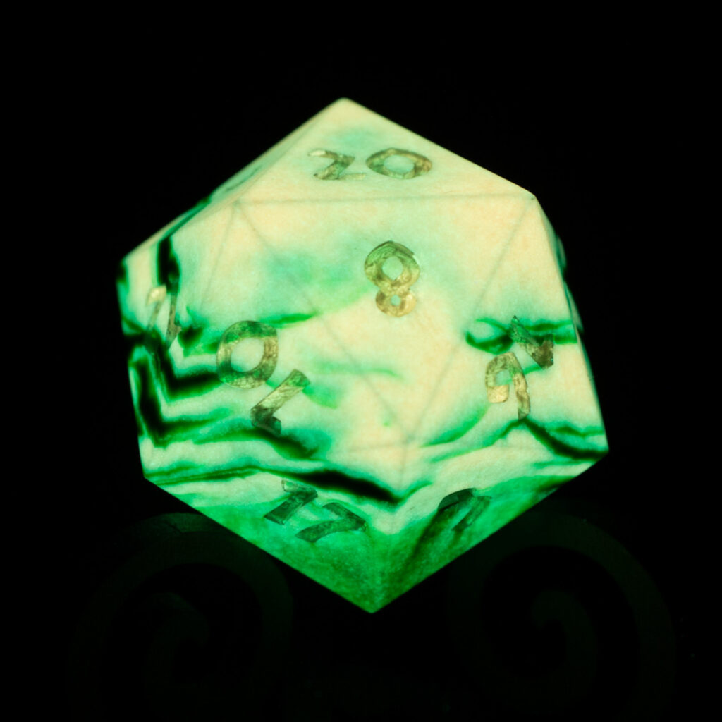 42mm Jesmonite 20-sided die glowing in the dark with an organic stripey pattern of dark green and glowing orange.