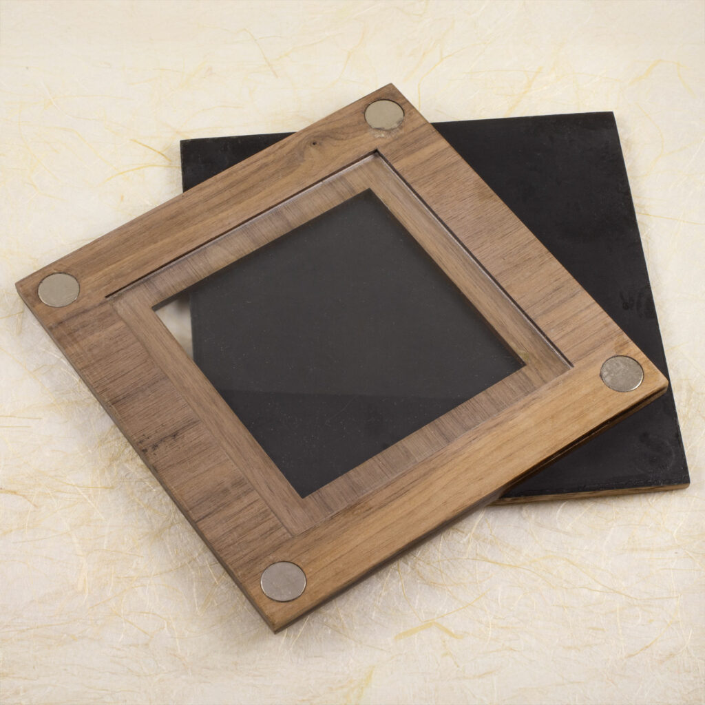 7cm print frame, open with the back off, showing the UV acrylic, magnet closures, and the black inside of the back panel.