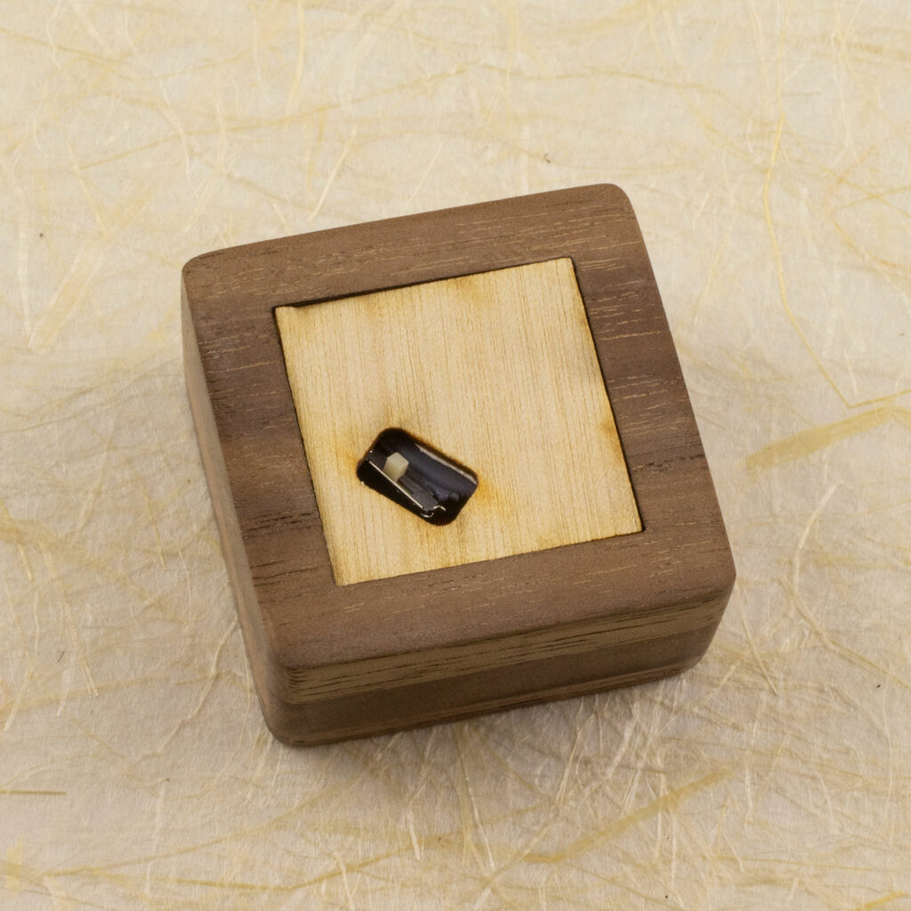 Bottom view of the small light-up stand. A small square of very thin plywood fills the opening, and has a cut-out to allow access to the tiny on/off switch.
