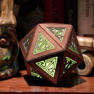 Copper rechargeable icosahedron with yellow light sits on a bookshelf