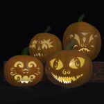 A 3D render of four jack-o-lanterns on and in front of a brick wall. The foremost jack-o-lantern, this year’s, in the lower right, has big cat-like eyes with spirals for pupils, two spirals arranged as a nose, and a jagged crooked grin. The jack-o-lanterns are all lit from within by candles.